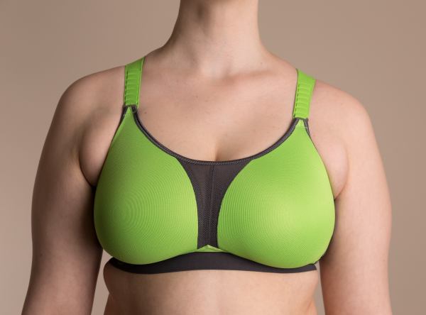 A person wearing a green and black sports bra