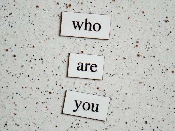 Magnetic poetry words saying 'Who are you'