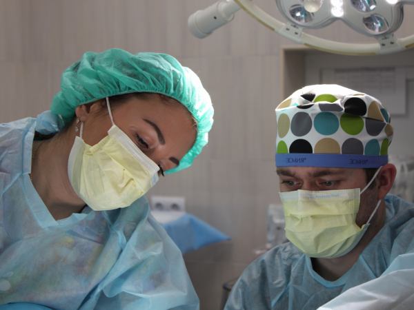 Faces of surgeons performing surgery