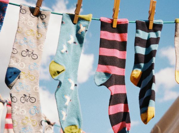 Brightly-coloured socks on a washing line.